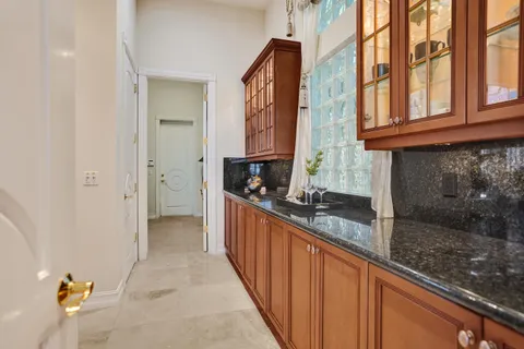 a kitchen with granite countertop a sink and cabinets