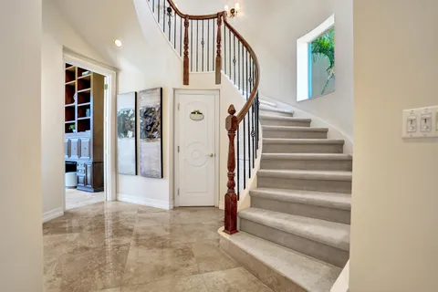 a view of entryway with wooden floor and front door