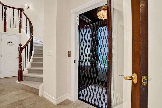 a view of a hallway with wooden floor and entryway