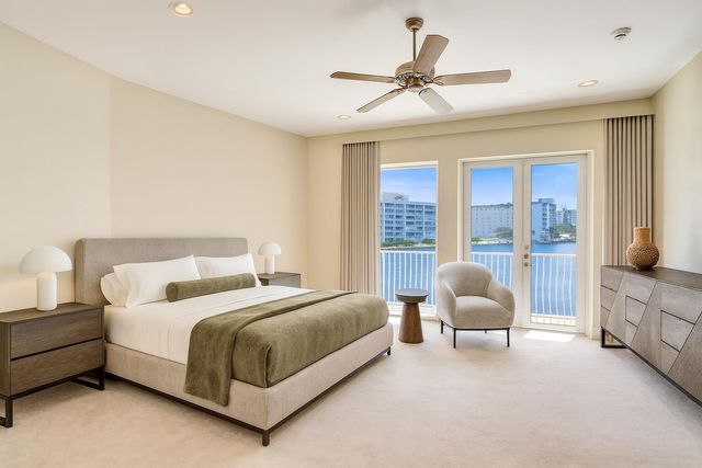 a bedroom with a bed a couch and a large window