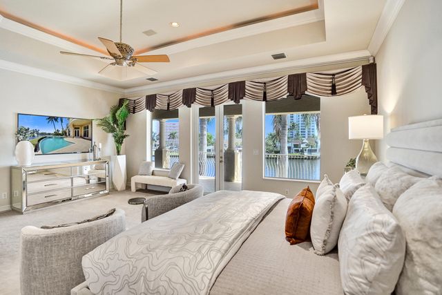 a bedroom with furniture and a large window