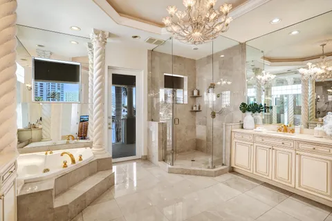 a large spacious bathroom with a large tub shower and sink