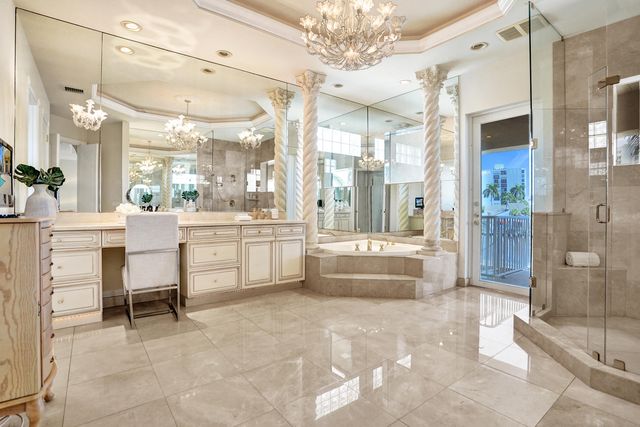 a large white kitchen with a large tub and sink