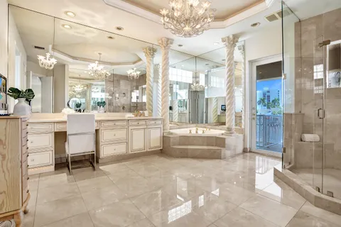 a large white kitchen with a large tub and sink