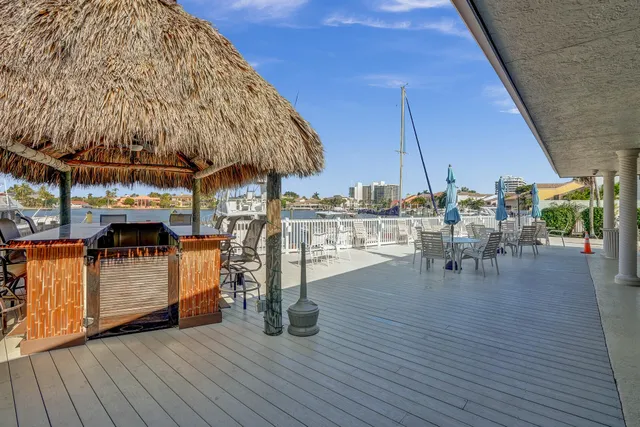 a view of outdoor kitchen with a table and chairs