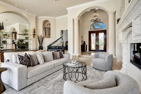 a living room with furniture and painting on the wall