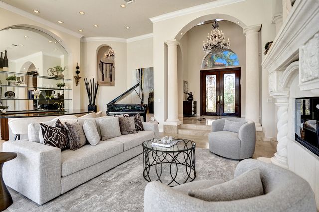 a living room with furniture and painting on the wall