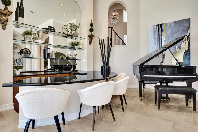 a kitchen with stainless steel appliances kitchen island a table and chairs in it
