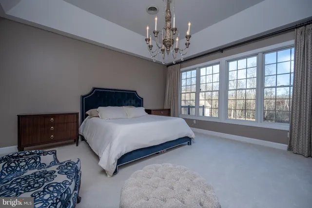 a living room with furniture a lamp and a chandelier