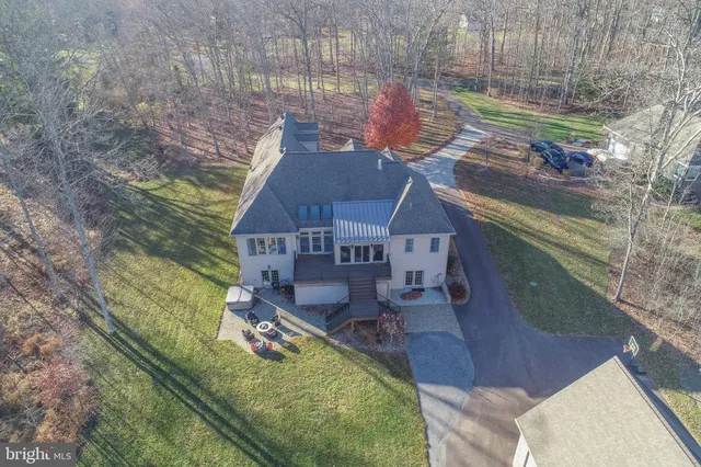 a living room with furniture a chandelier and a rug