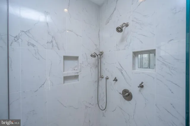 a living room with furniture and a dining table with kitchen view
