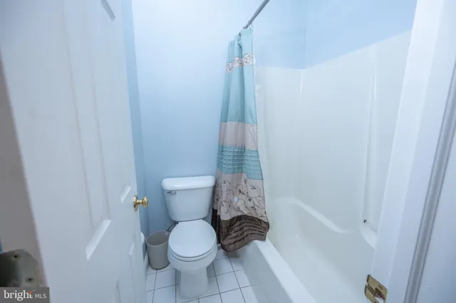a bathroom with a granite countertop sink a toilet and a mirror