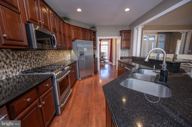 a view of a dining room with furniture wooden floor and a chandelier