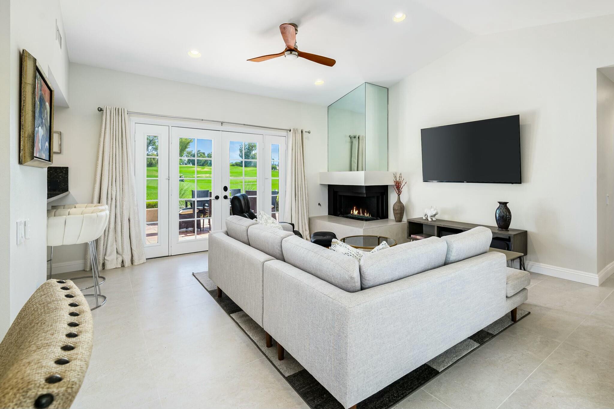 38 Mission Court Rancho Mirage, CA 92270 - Photo 25 of 61 a living room with furniture and a flat screen tv