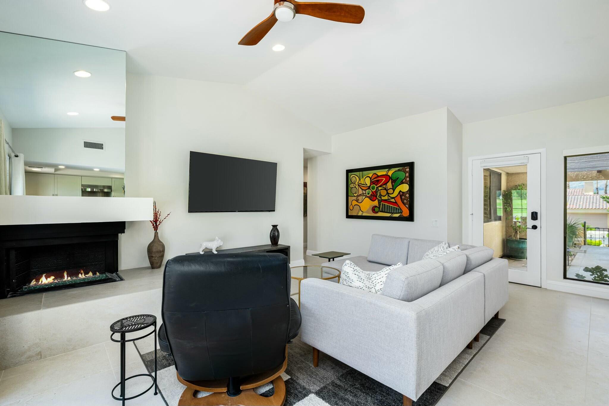 38 Mission Court Rancho Mirage, CA 92270 - Photo 29 of 61 a living room with furniture and a fireplace