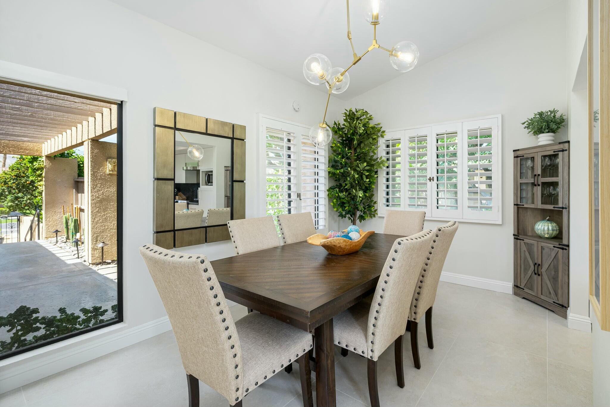 38 Mission Court Rancho Mirage, CA 92270 - Photo 32 of 61 a view of a dining room with furniture window and wooden floor