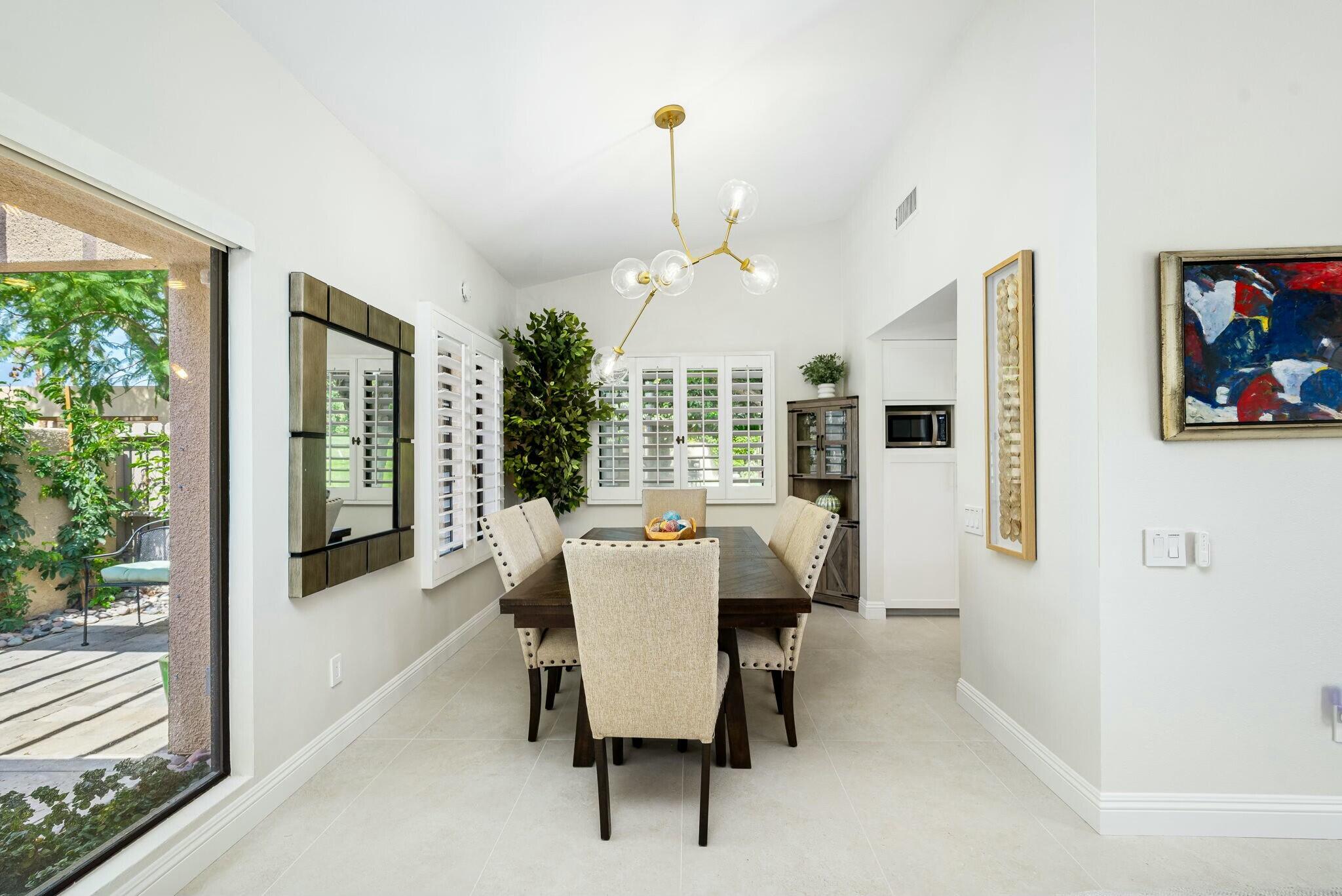 38 Mission Court Rancho Mirage, CA 92270 - Photo 33 of 61 a dining room with furniture a chandelier and window