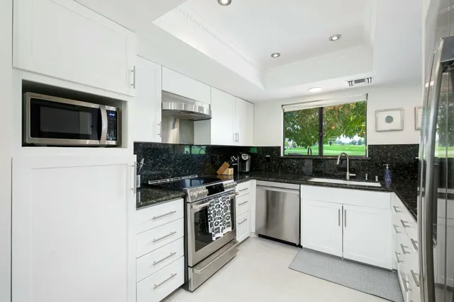 a view of a patio with table and chairs and garden