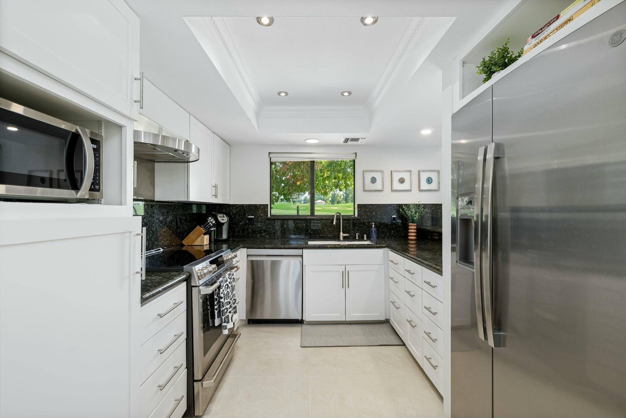 38 Mission Court Rancho Mirage, CA 92270 - Photo 36 of 61 a kitchen with stainless steel appliances a stove sink and refrigerator