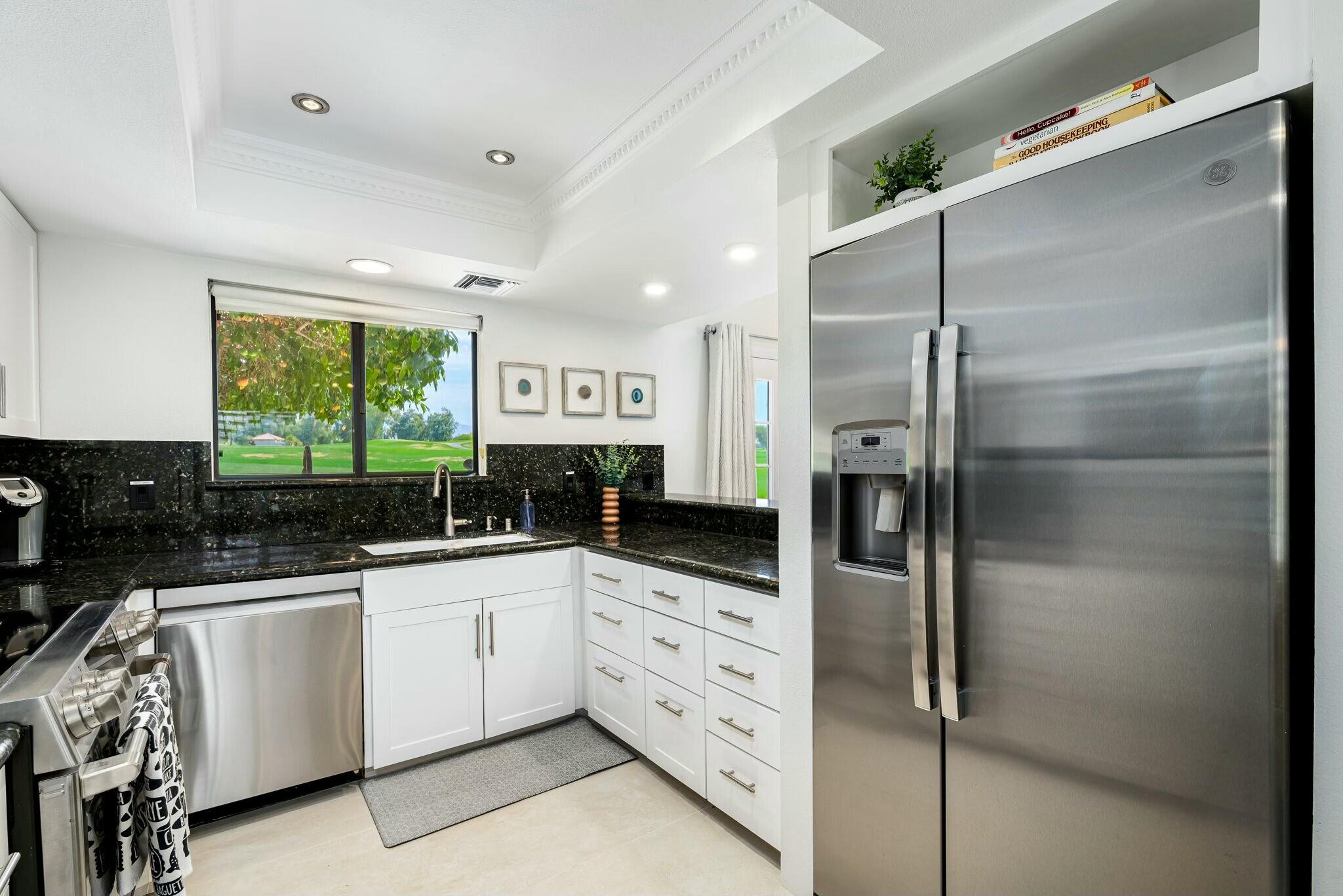 38 Mission Court Rancho Mirage, CA 92270 - Photo 37 of 61 a kitchen with white cabinets and appliances
