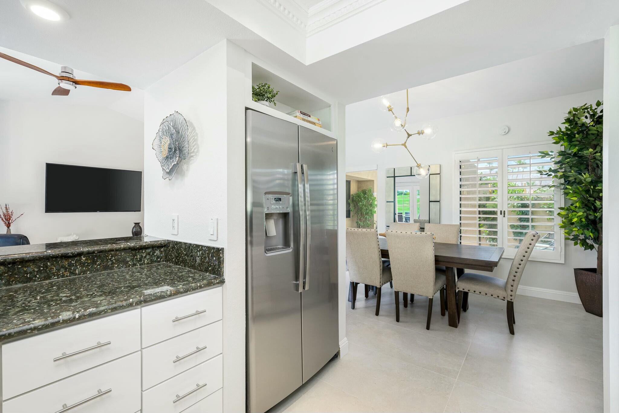 38 Mission Court Rancho Mirage, CA 92270 - Photo 39 of 61 a kitchen with stainless steel appliances kitchen island granite countertop a refrigerator and cabinets