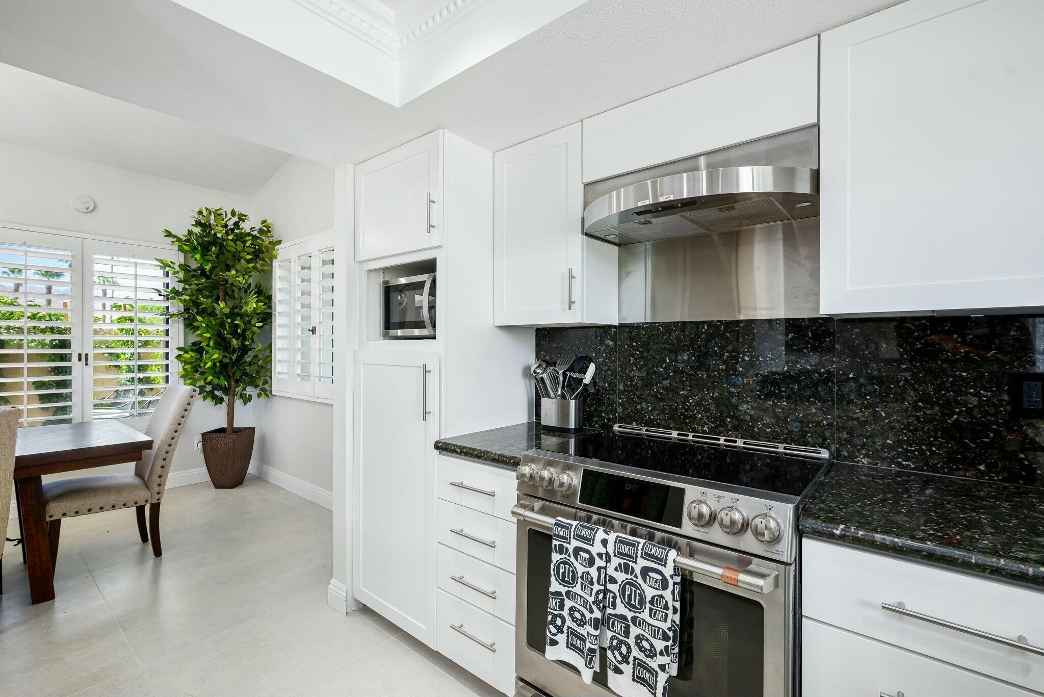 38 Mission Court Rancho Mirage, CA 92270 - Photo 40 of 61 a kitchen with stainless steel appliances a stove and a refrigerator