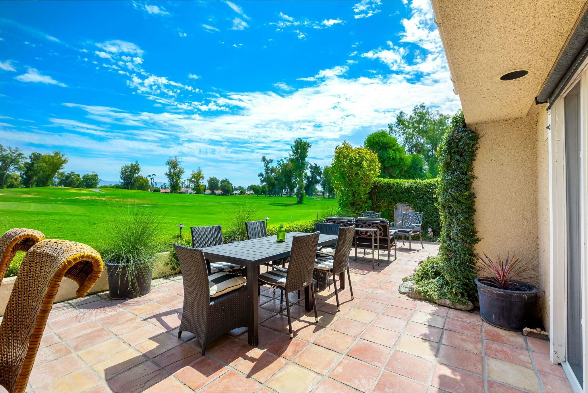 38 Mission Court Rancho Mirage, CA 92270 - Photo 43 of 61 a view of a patio with a table and chairs