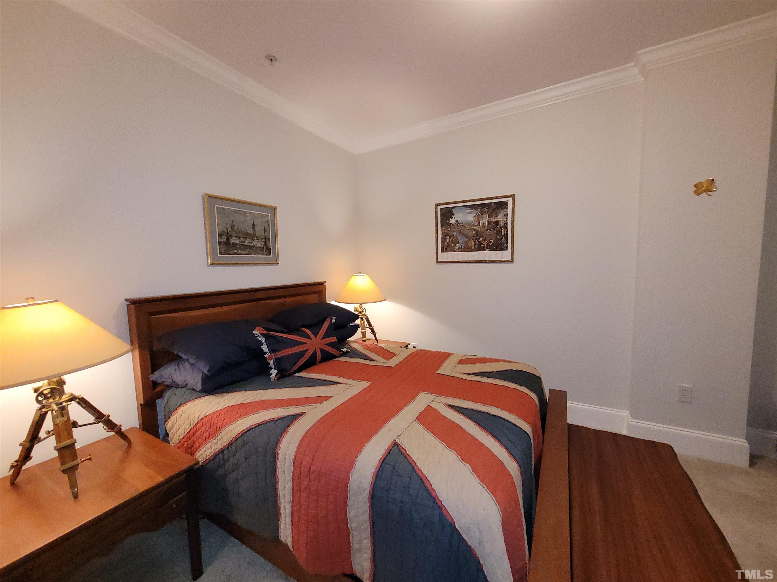 710 Independence Place, Unit 208/2C Raleigh, NC 27603 - Photo 12 of 29 a bedroom with bed and wooden floor