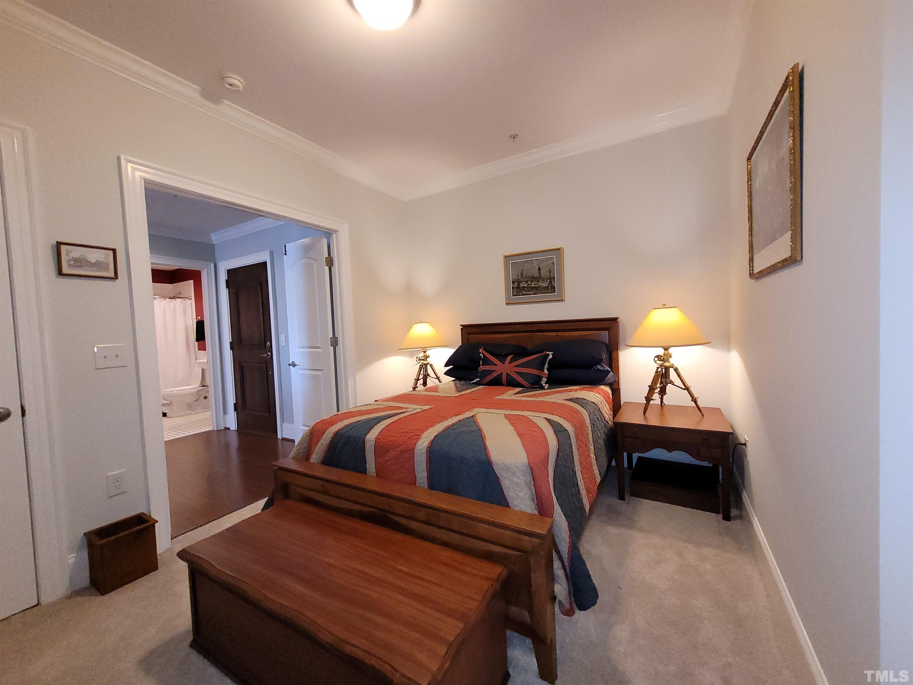 710 Independence Place, Unit 208/2C Raleigh, NC 27603 - Photo 13 of 29 a bedroom with a bed and a lamp
