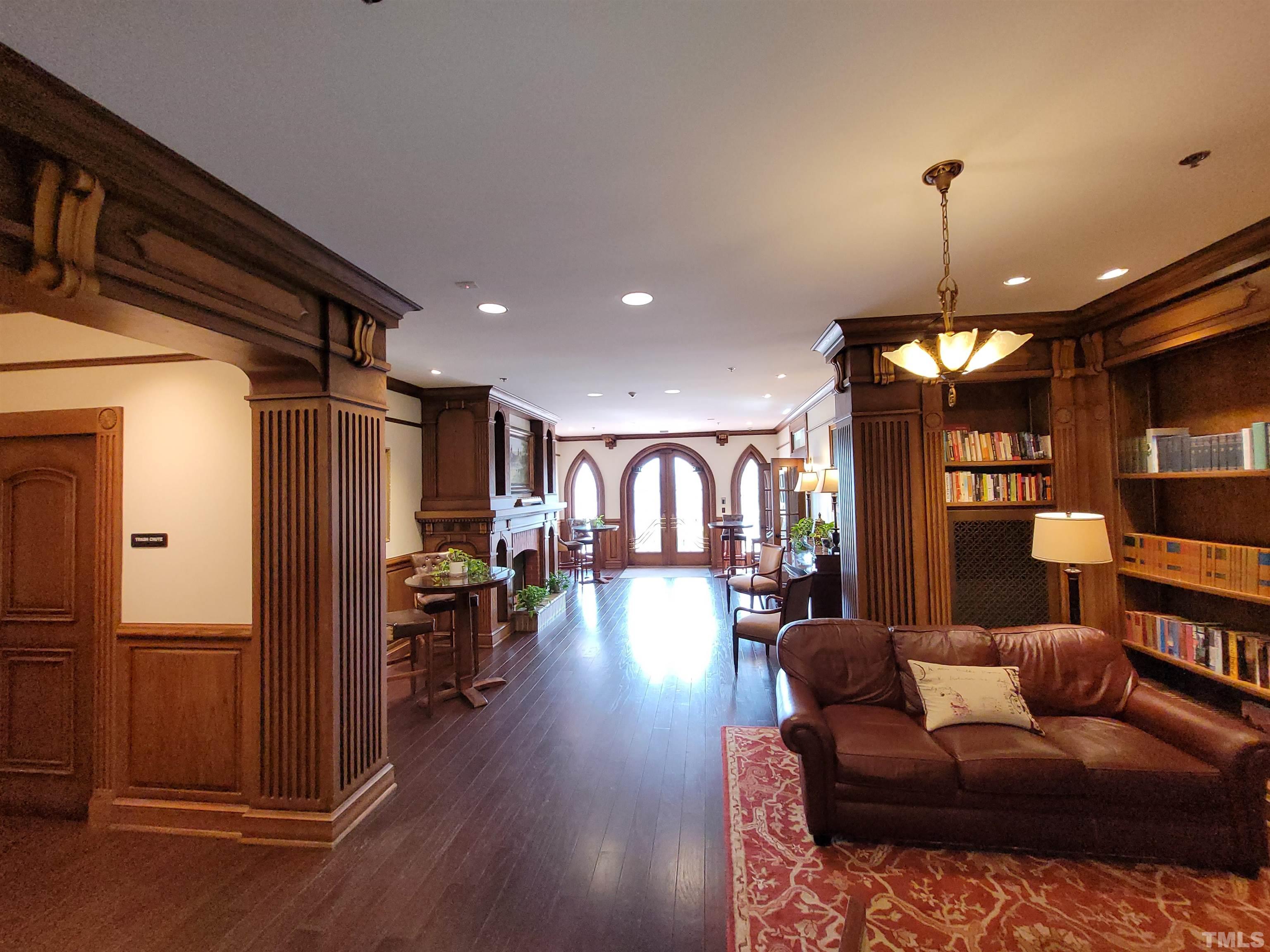 710 Independence Place, Unit 208/2C Raleigh, NC 27603 - Photo 19 of 29 a living room with furniture a chandelier and wooden floor