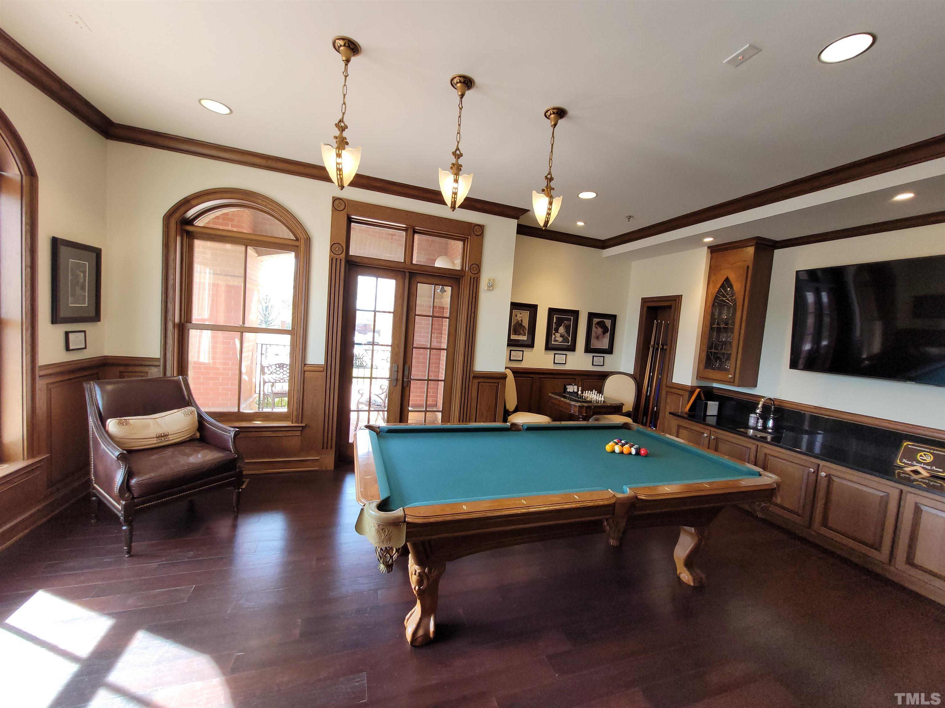 710 Independence Place, Unit 208/2C Raleigh, NC 27603 - Photo 20 of 29 a living room with furniture pool table wooden floor and windows