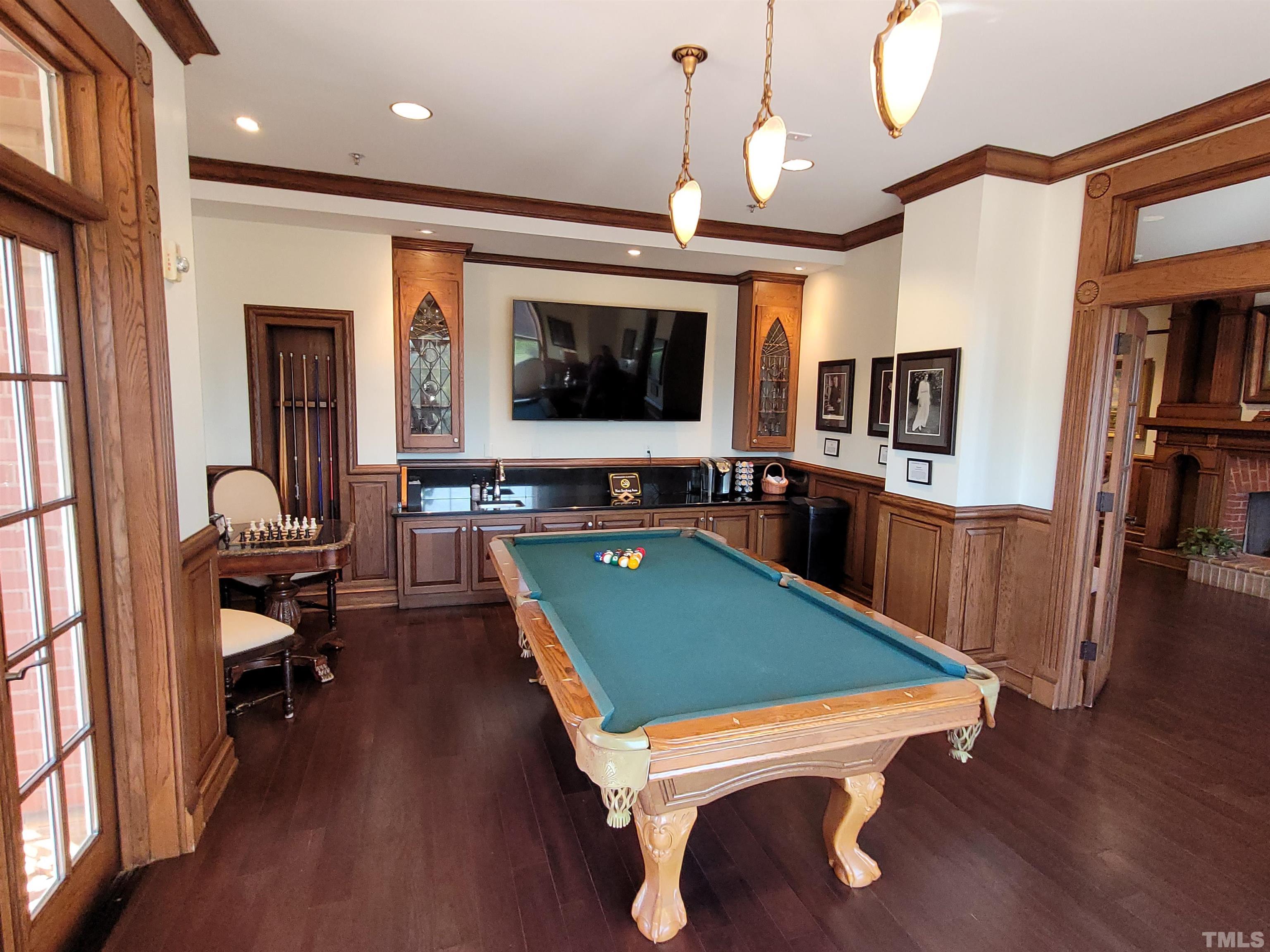 710 Independence Place, Unit 208/2C Raleigh, NC 27603 - Photo 21 of 29 a room with furniture pool table flat screen tv and wooden floor