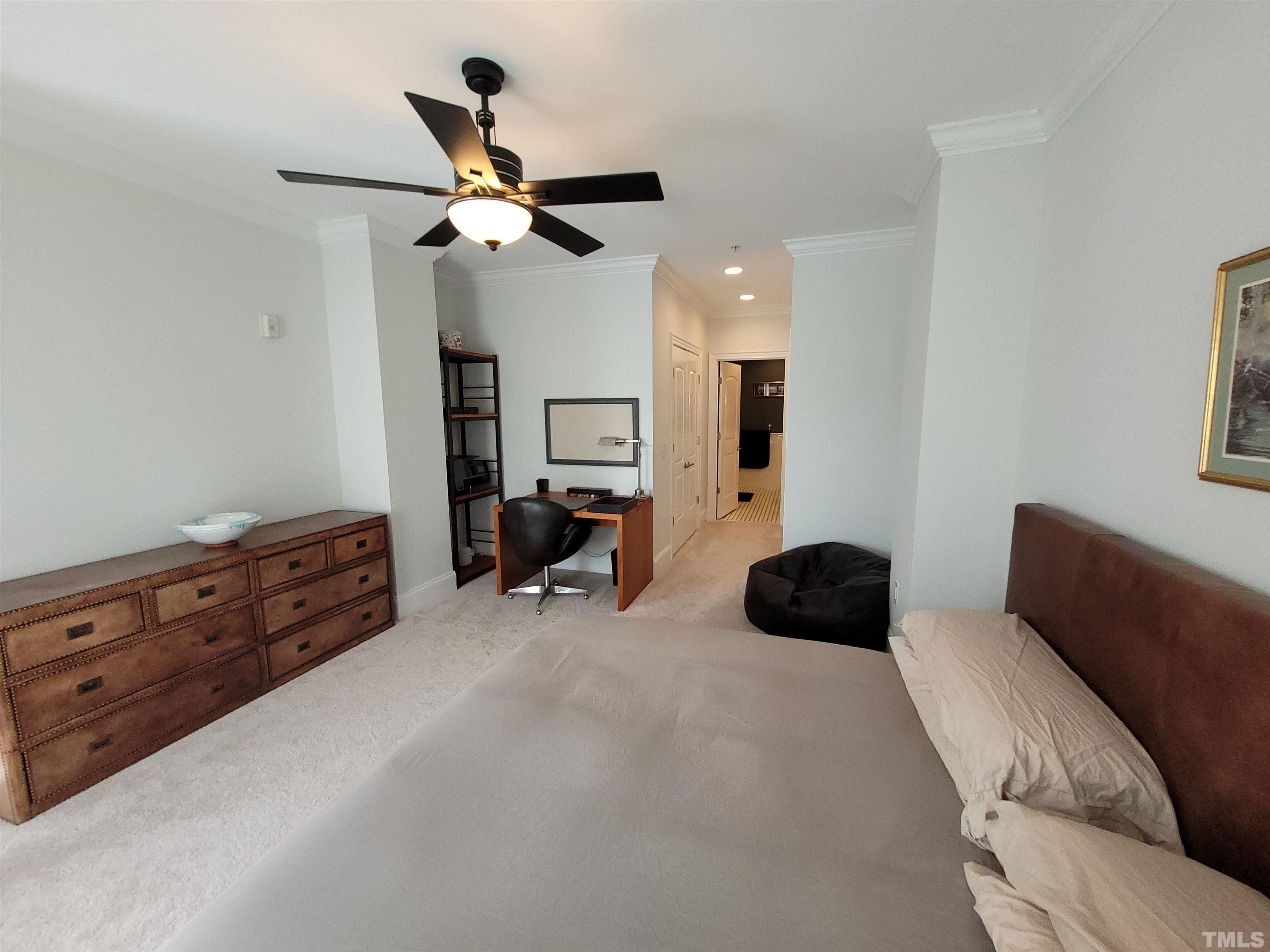 710 Independence Place, Unit 208/2C Raleigh, NC 27603 - Photo 6 of 29 a room with a couch and a ceiling fan