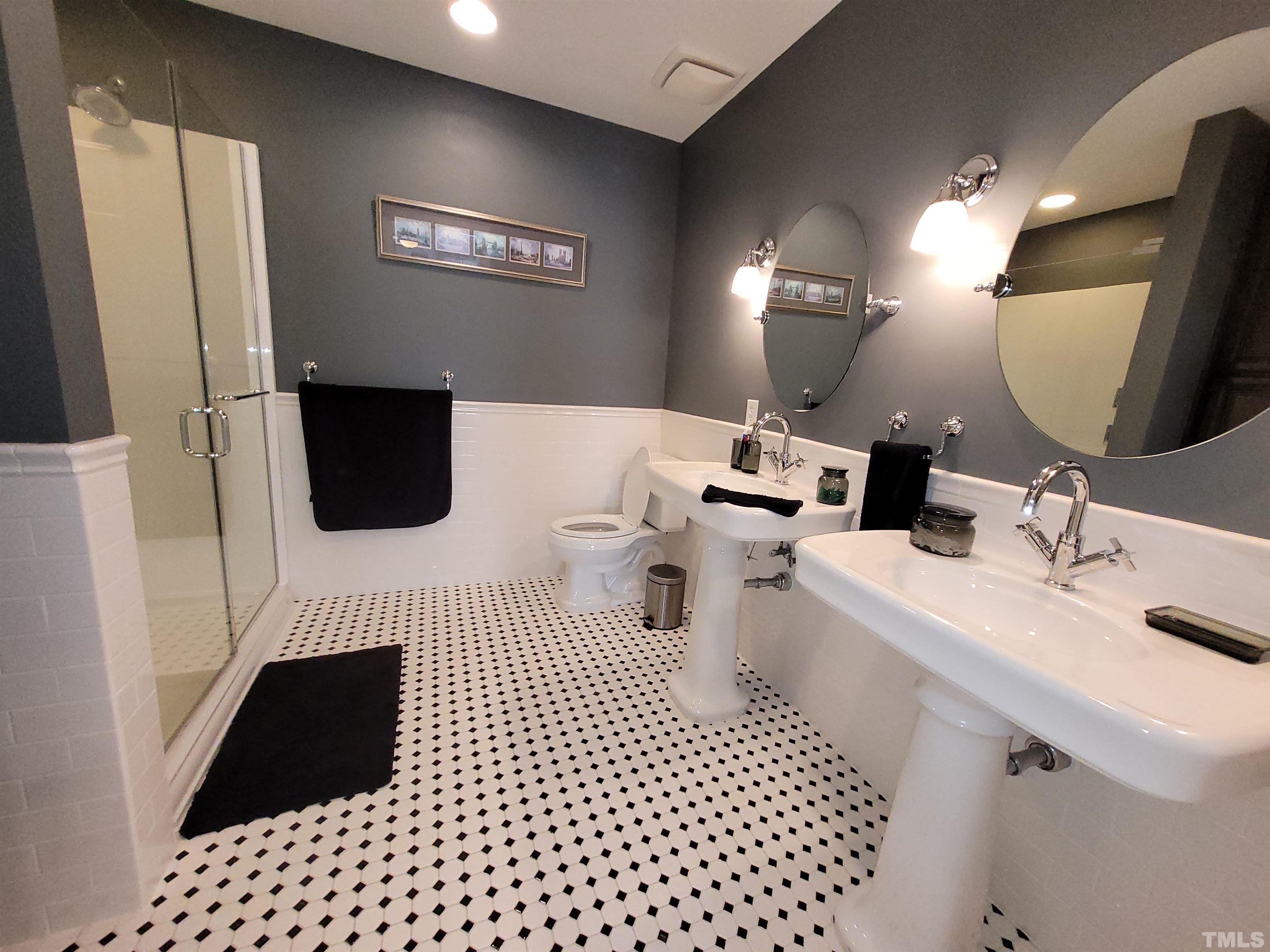 710 Independence Place, Unit 208/2C Raleigh, NC 27603 - Photo 7 of 29 a bathroom with a sink a toilet and a mirror