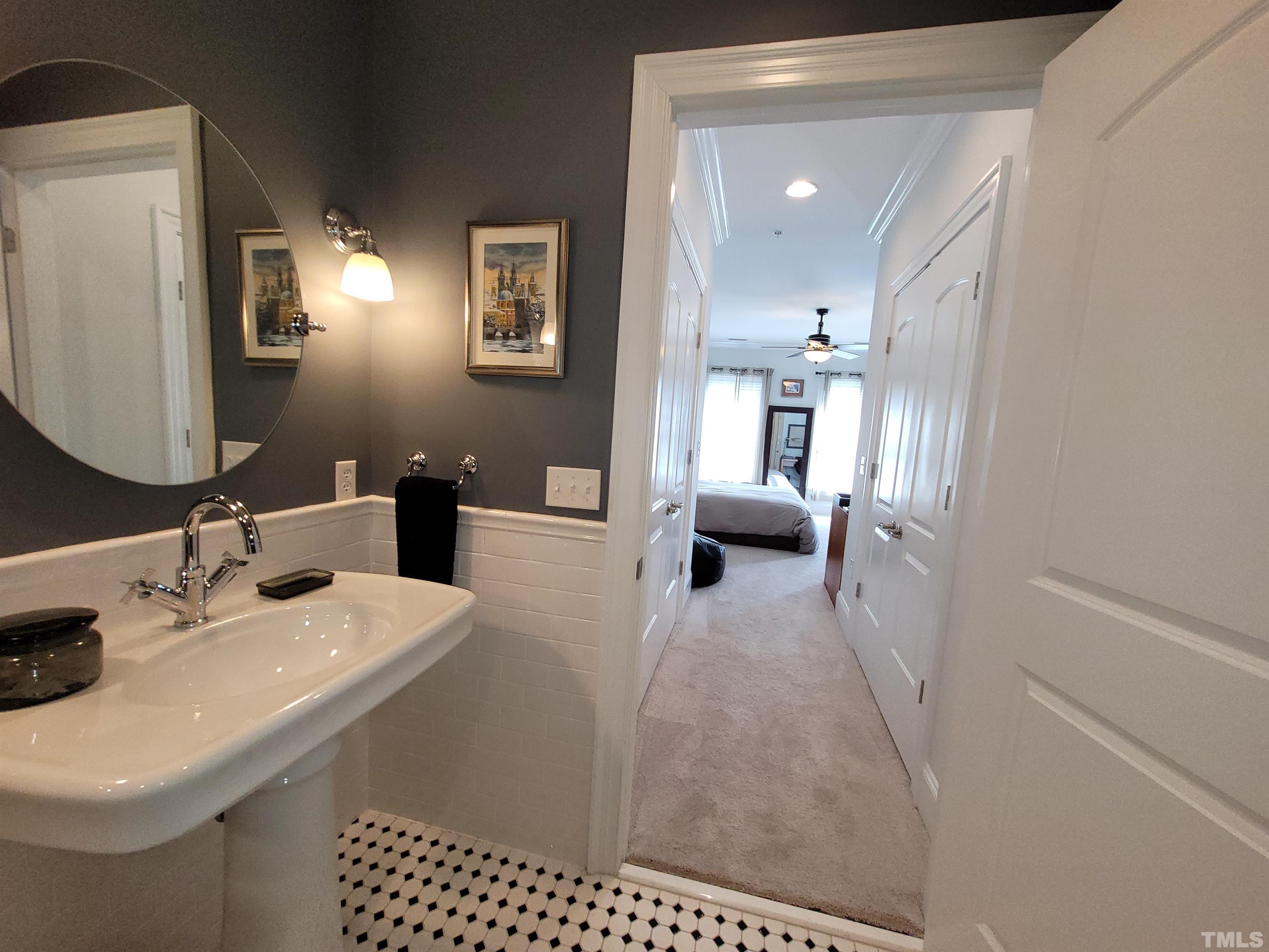 710 Independence Place, Unit 208/2C Raleigh, NC 27603 - Photo 8 of 29 a en suite bathroom with a sink and a mirror