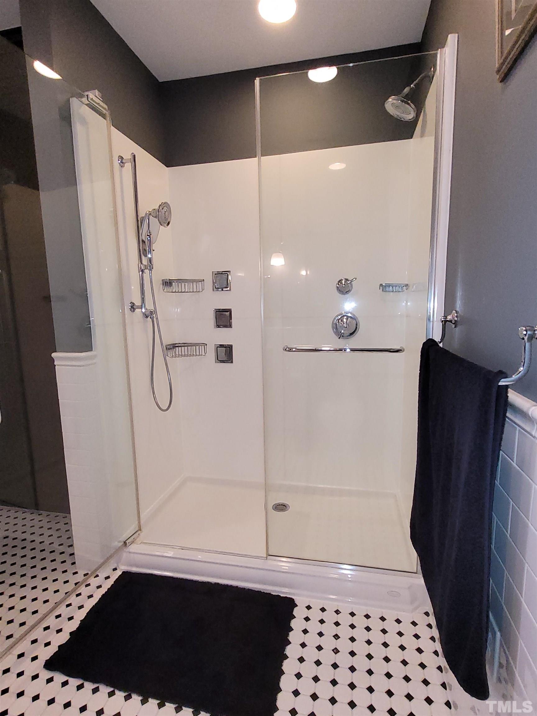 710 Independence Place, Unit 208/2C Raleigh, NC 27603 - Photo 9 of 29 a bathroom with a glass shower door and a sink