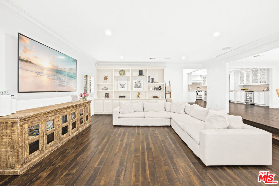 4844 Commonwealth Avenue La Canada Flintridge, CA 91011 - Photo 14 of 43 a large living room with stainless steel appliances wooden floors and white walls