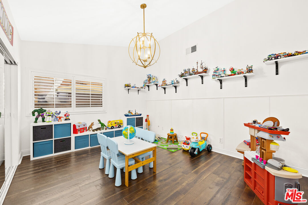 4844 Commonwealth Avenue La Canada Flintridge, CA 91011 - Photo 19 of 43 a view of a play room with furniture and wooden floor