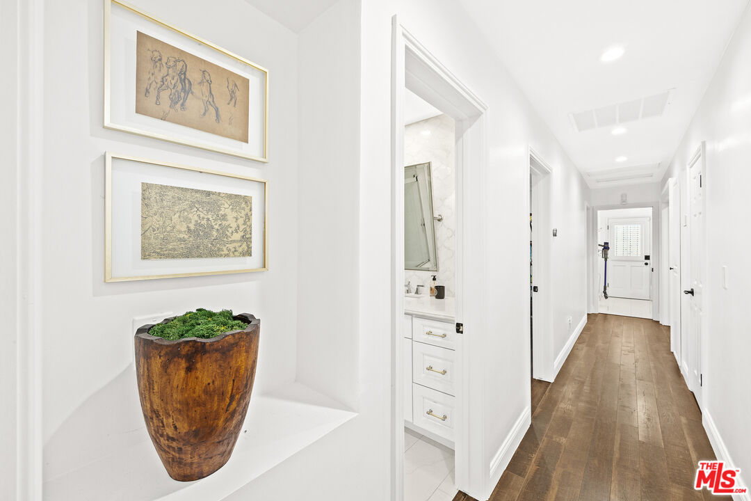 4844 Commonwealth Avenue La Canada Flintridge, CA 91011 - Photo 20 of 43 a view of a hallway with wooden floor and a potted plant