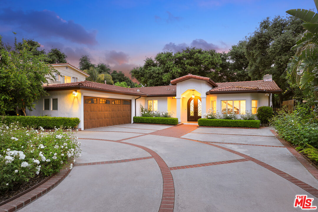 4844 Commonwealth Avenue La Canada Flintridge, CA 91011 - Photo 2 of 43 a front view of a house with a yard and garage