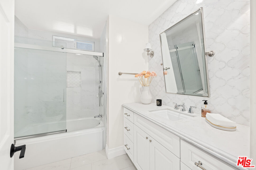 4844 Commonwealth Avenue La Canada Flintridge, CA 91011 - Photo 21 of 43 a bathroom with a bathtub shower sink vanity and mirror