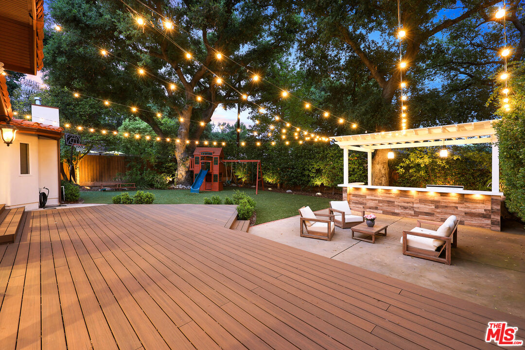 4844 Commonwealth Avenue La Canada Flintridge, CA 91011 - Photo 34 of 43 a view of a patio with dining table and chairs with wooden floor and fence
