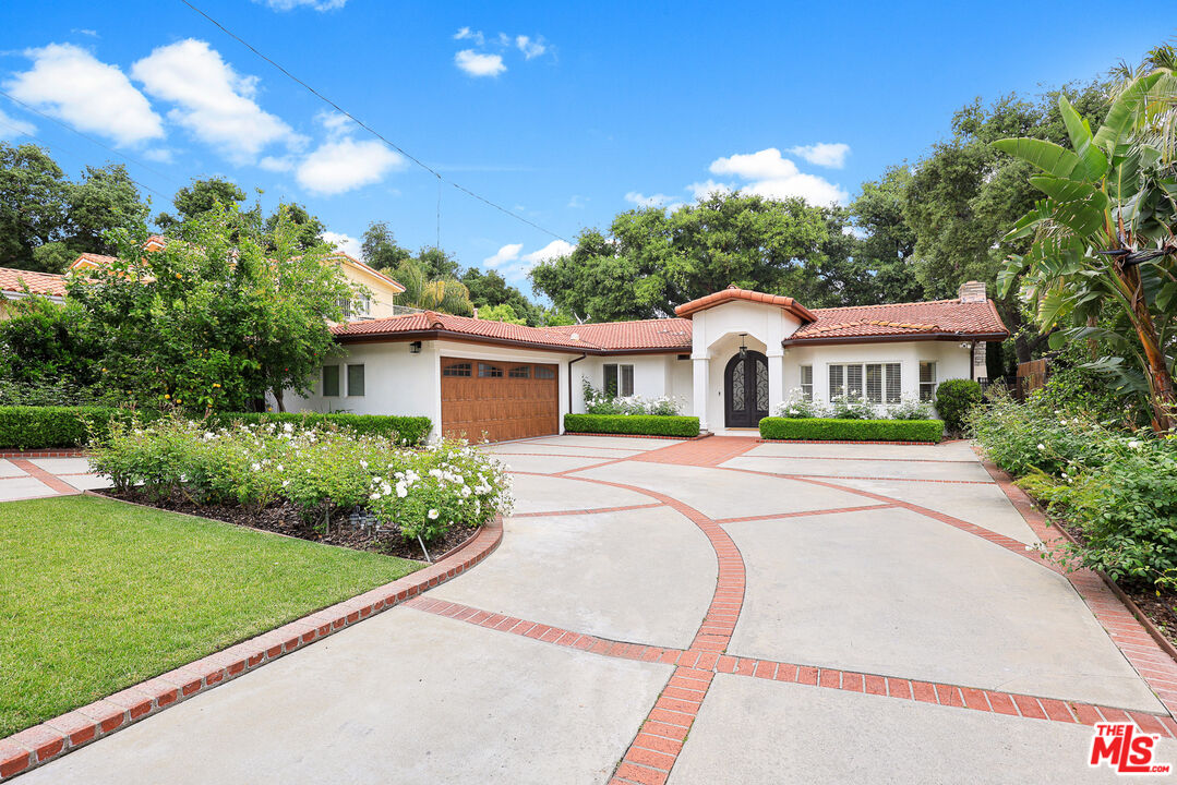 4844 Commonwealth Avenue La Canada Flintridge, CA 91011 - Photo 4 of 43 a front view of a house with garden