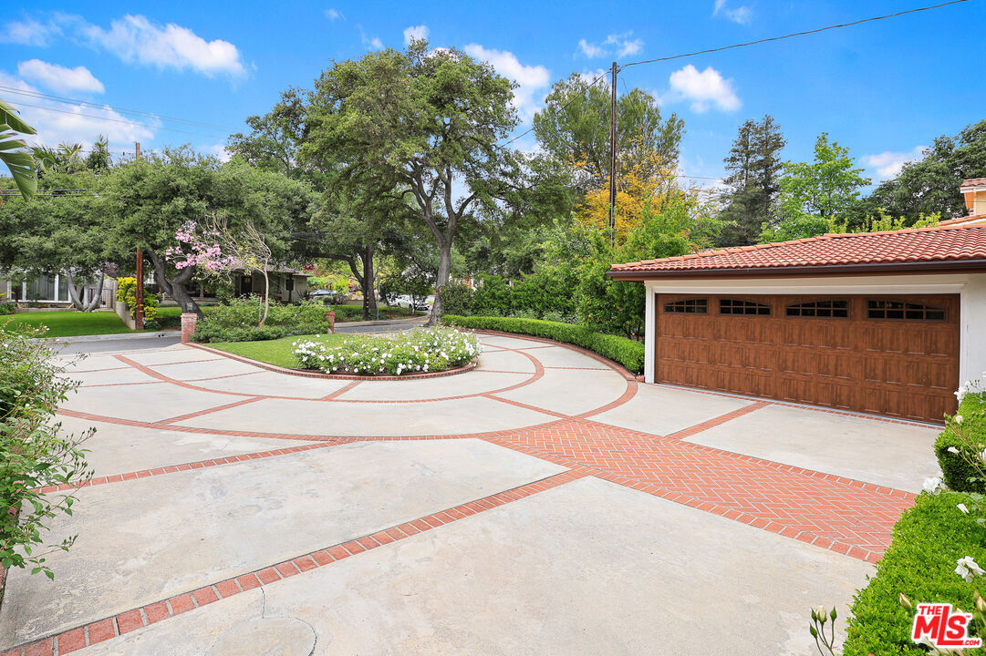 4844 Commonwealth Avenue La Canada Flintridge, CA 91011 - Photo 5 of 43 a front view of a house with a yard and garage