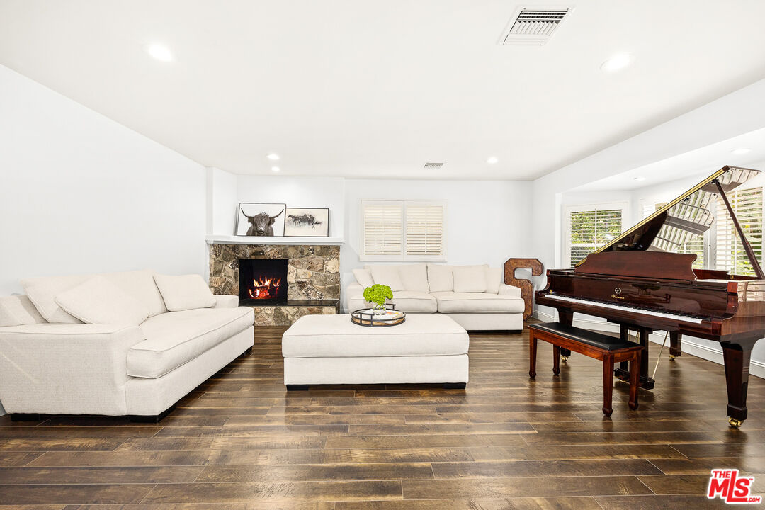 4844 Commonwealth Avenue La Canada Flintridge, CA 91011 - Photo 10 of 43 a living room with fireplace furniture and a wooden floor