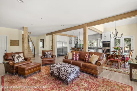 a living room with furniture and large windows
