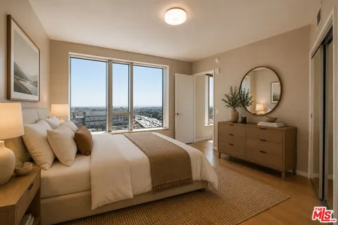 a bedroom with a bed and large windows