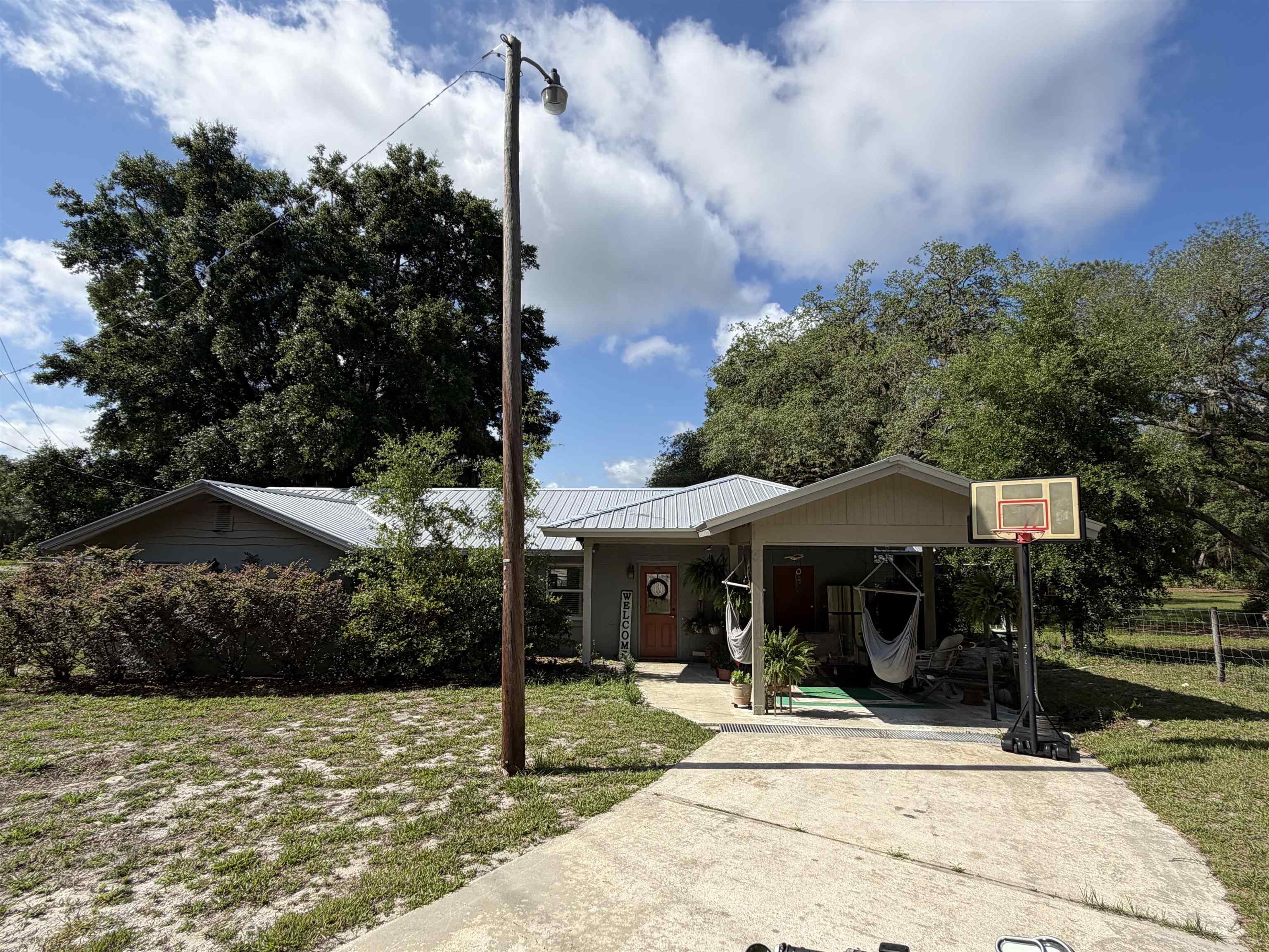 323 Sisco Road Pomona Park, FL 32181 - Photo 2 of 31 a front view of a house with garden