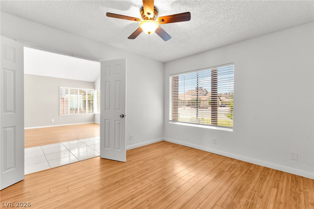 4430 Cranbrook Way Las Vegas, NV 89103 - Photo 25 of 50 A versatile room featuring light wood flooring and a refreshing ceiling fan, ideal for a home office or guest quarters.