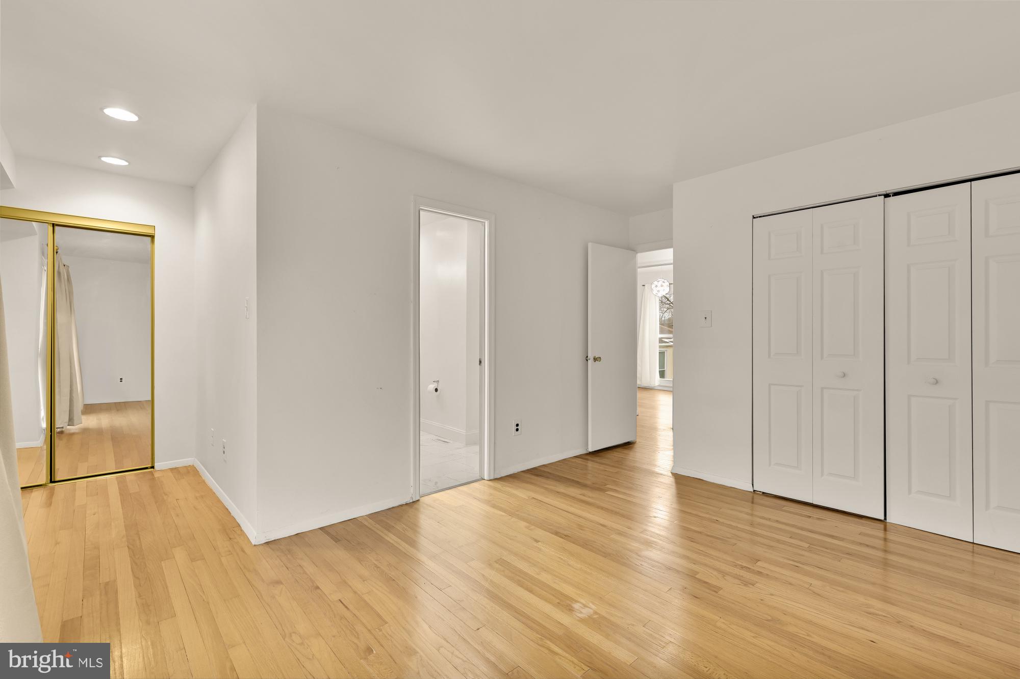 7149 Mill Run Drive, Unit 155 Rockville, MD 20855 - Photo 14 of 22 a view of an empty room with wooden floor